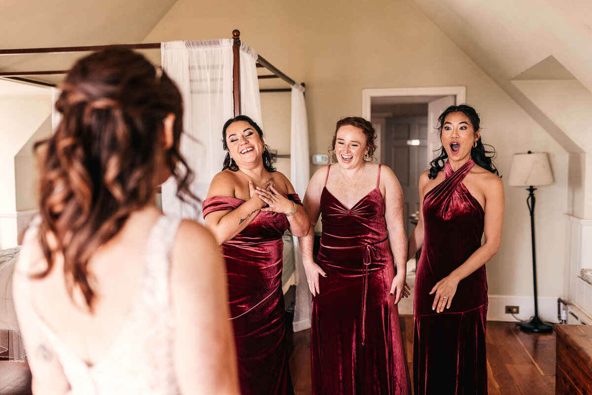 The bridal party seeing the bride for the first time in the bridal suite at Cobb Hill Estate NH by Lisa Smith Photography