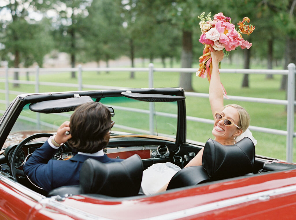 Bride with Bouquet in Red Convertible