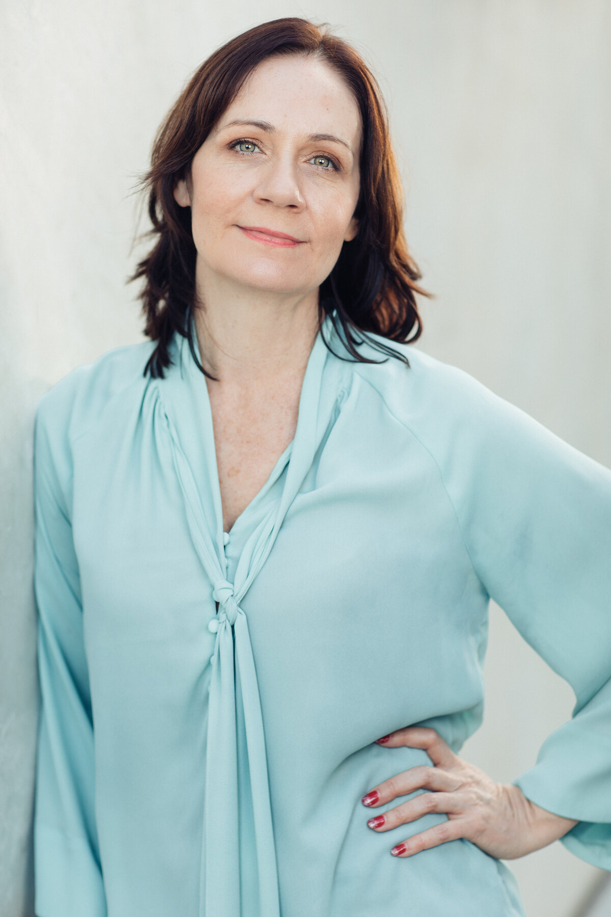 Headshot Photograph Of Woman In Light Blue Blouse Los Angeles
