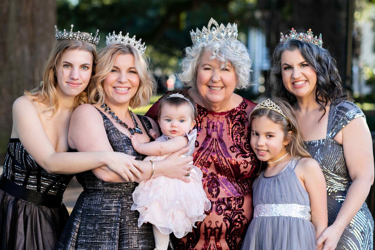 family of women portrait wearing crowns