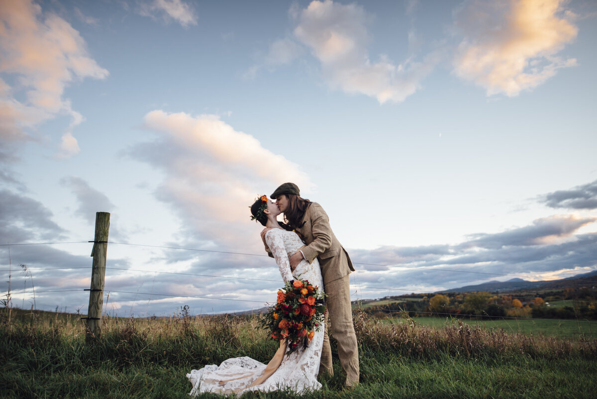 kissing couple on apple orchard during sunset