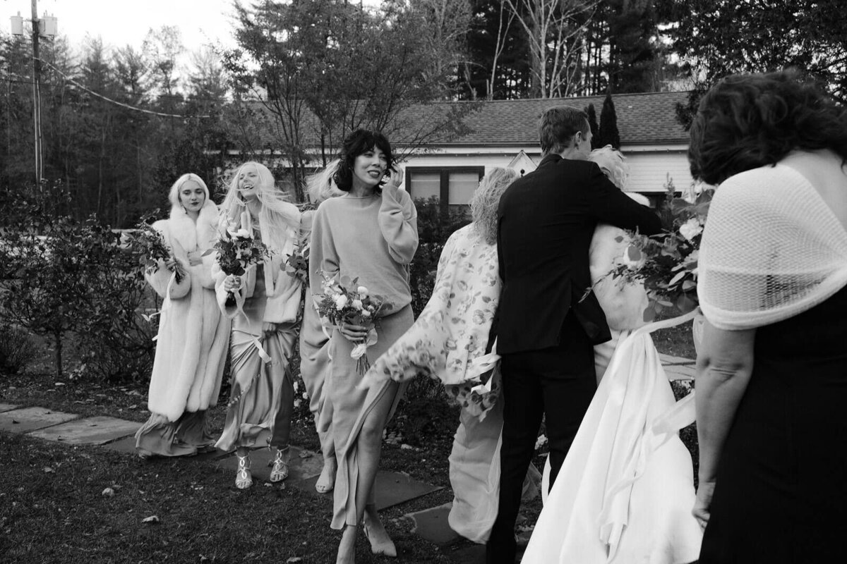 The groom hugging the bride outside the Foxfire Mountain House, New York. Wedding Image by Jenny Fu Studio