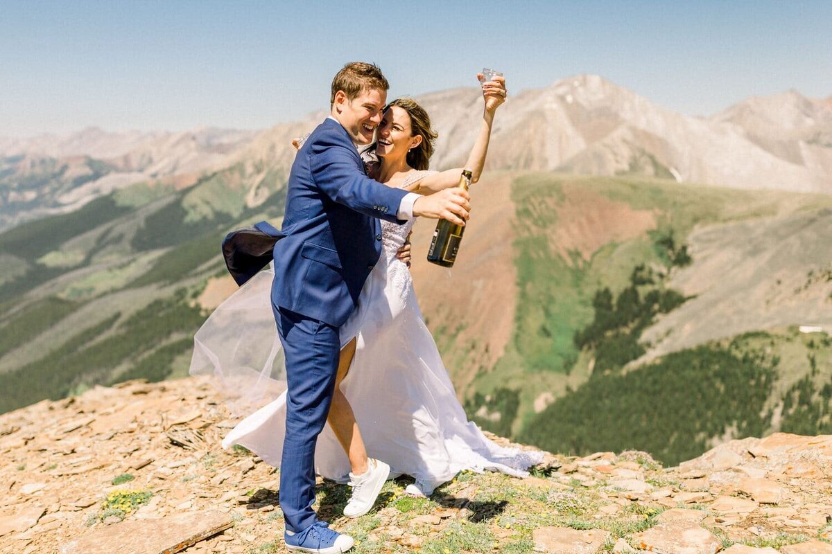 champagne-being-enjoyed-after-a-bride-and-grrom-got-married-on-top-of-the-mountain