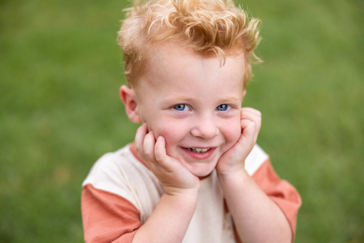 close-up of little by with red hair in Cerulean Park at Watercolor, Florida by Gwyne Gray Photography