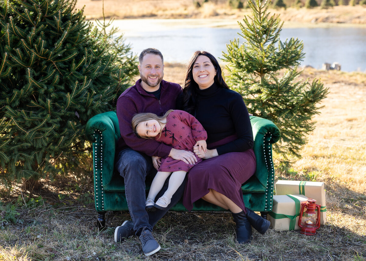 Family photo on a couch decorated for the holidays at a Christmas tree farm in Somerset County, NJ