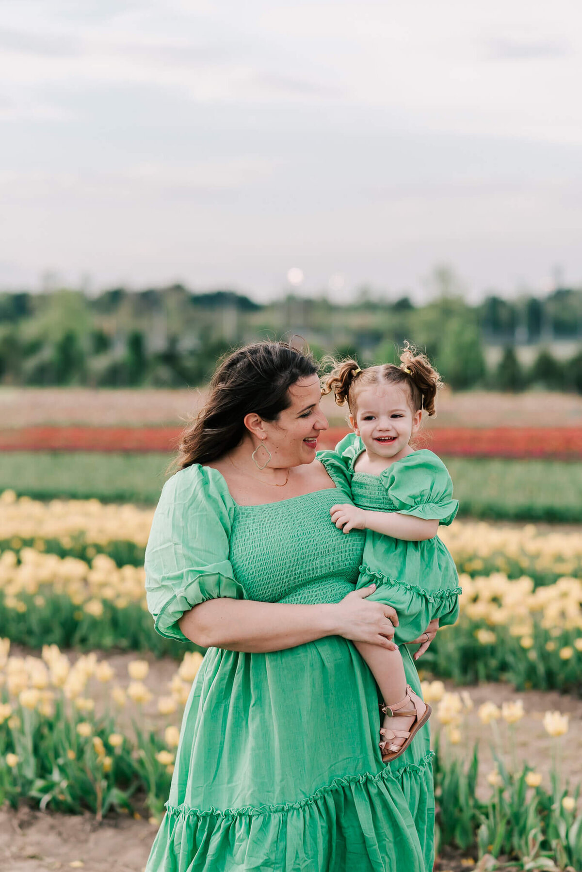A woman holding her daughter in her arms by Denise Van Photography, a northern VA family photographer