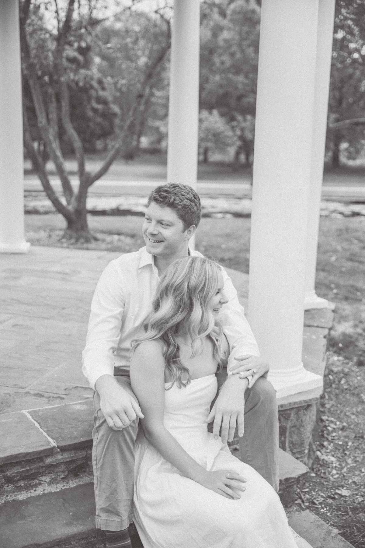 Couple sitting on gazebo steps in PA during engagement session