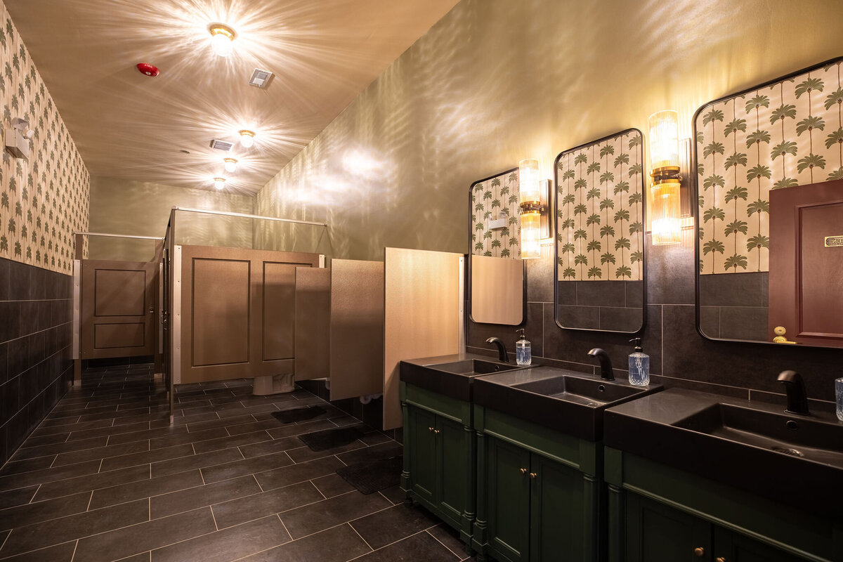 wide shot of Bloom Events men's restroom with subtle masculine design details of wallpaper and color story