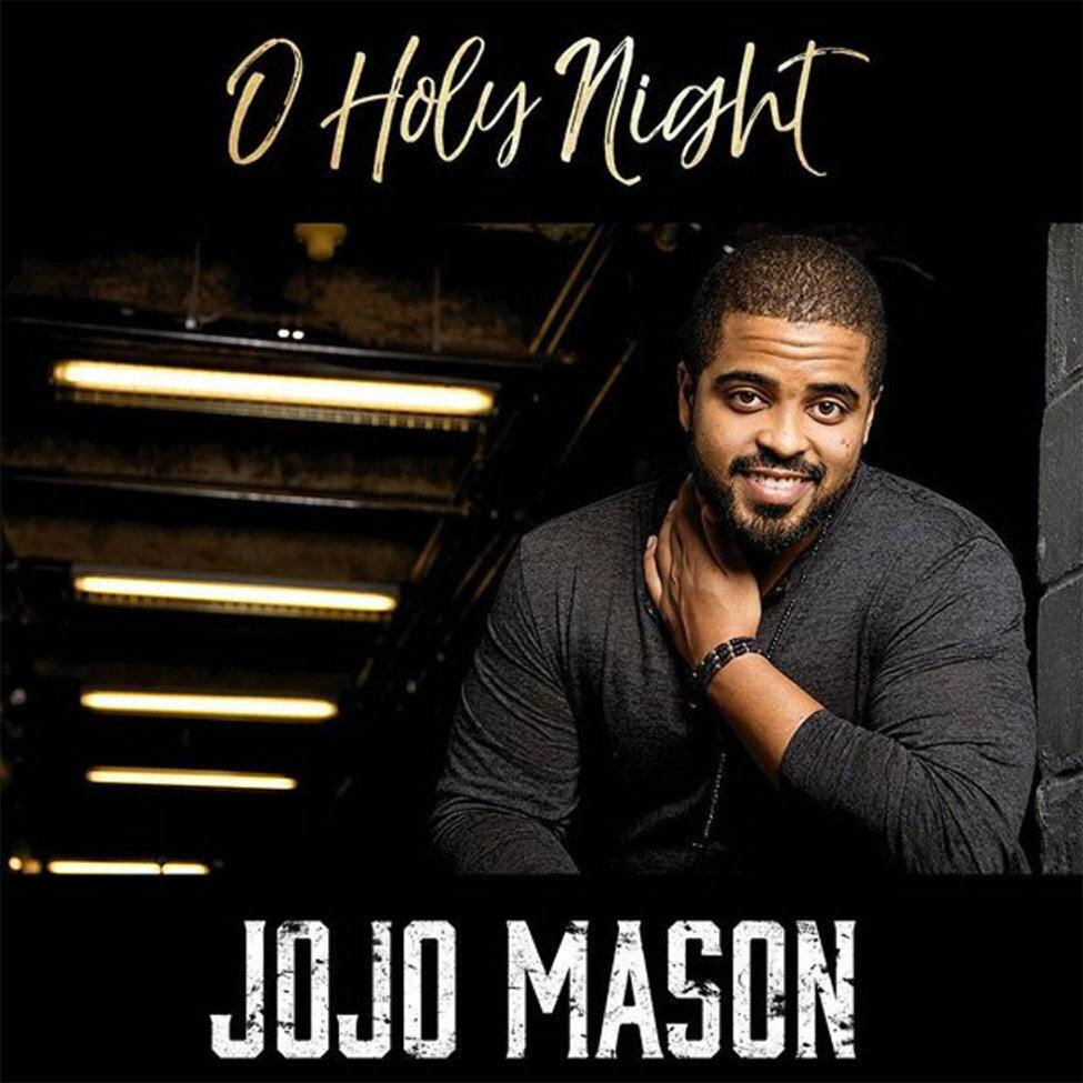 Christmas Single Cover O Holy Night Artist JoJo Mason standing beneath lights of tunnel hand to his neck