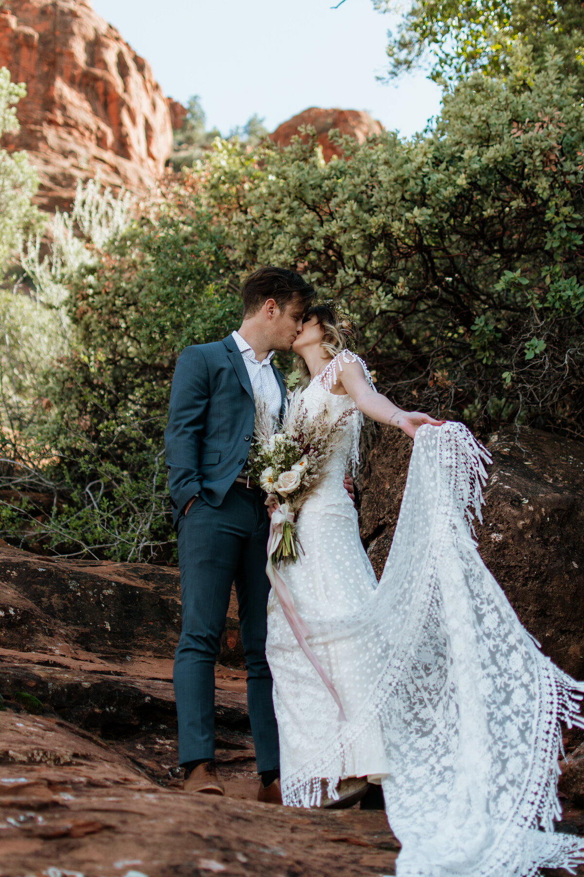Bride and groom kissing at altar