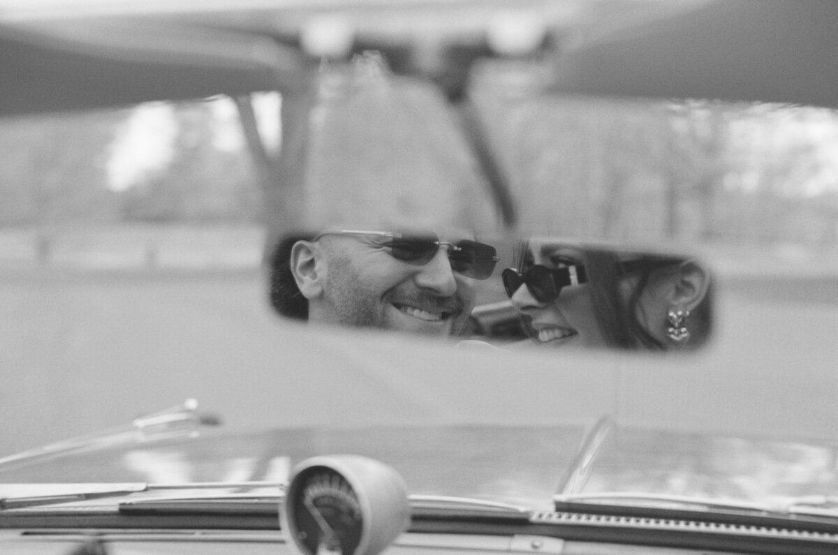 35mm film engagement photo at Vanderbilt Mansion of a couple in a vintage car