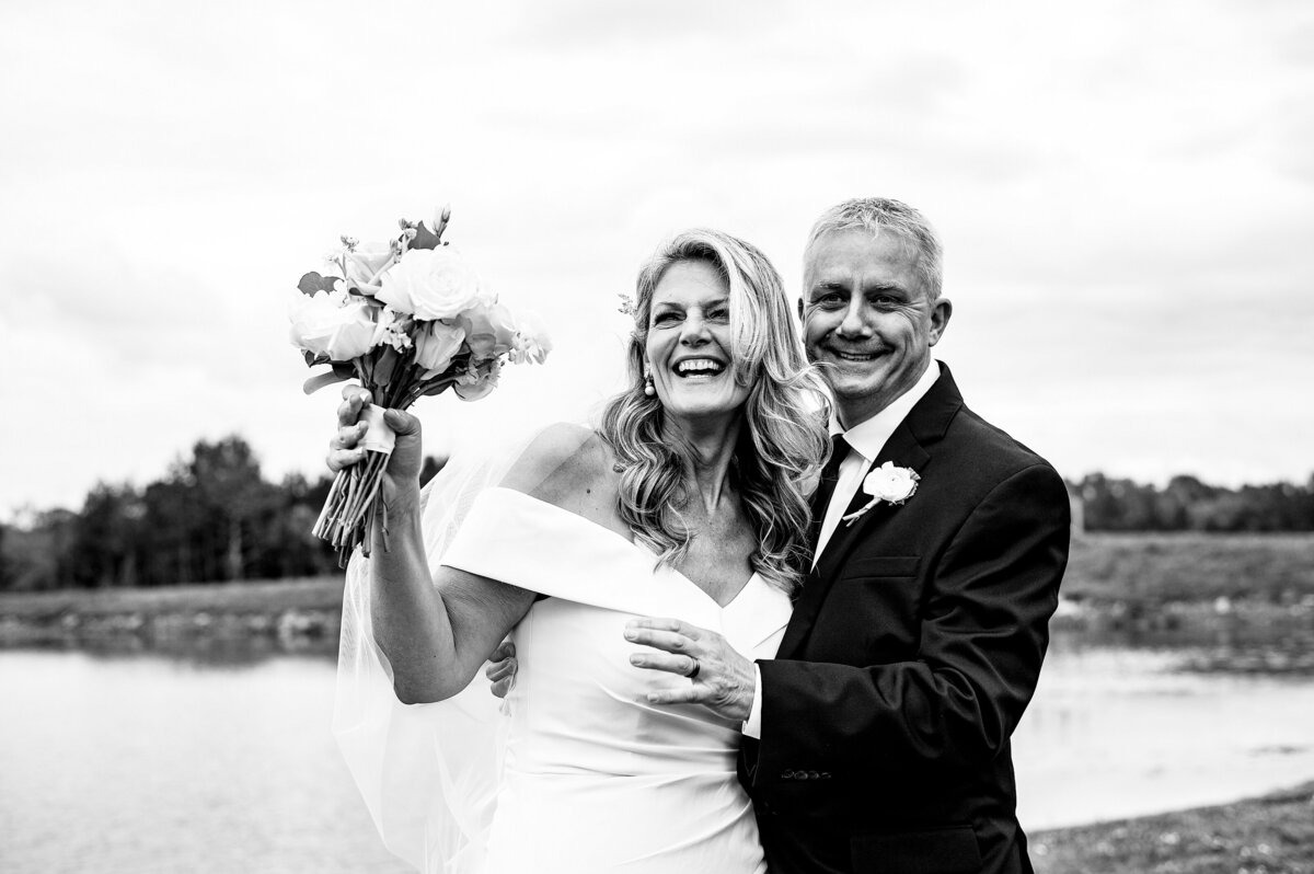 Bride and Groom smiling and waving at guests