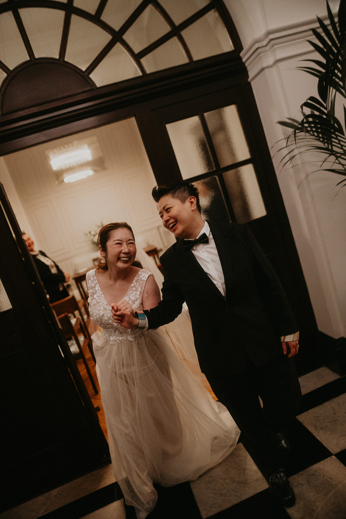 Same sex couple exit their wedding ceremony at Chelsea Town Hall in London.