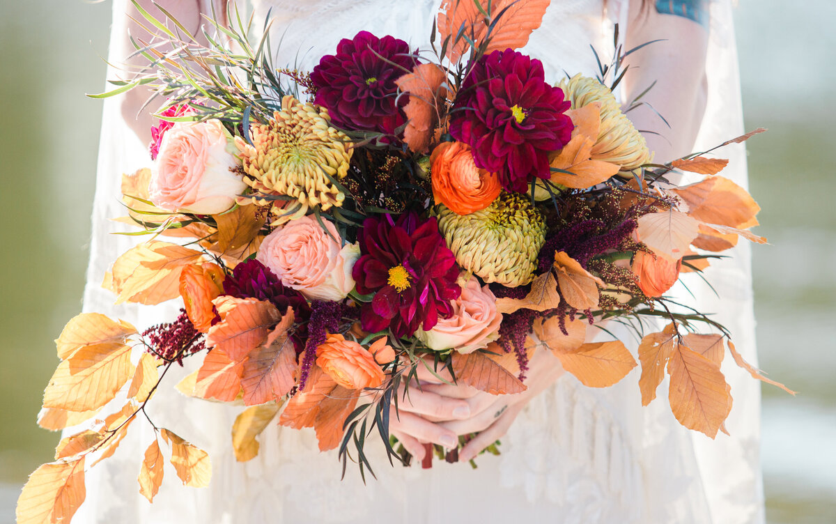 bride holding a fall boho wedding bouquet in Chattanooga