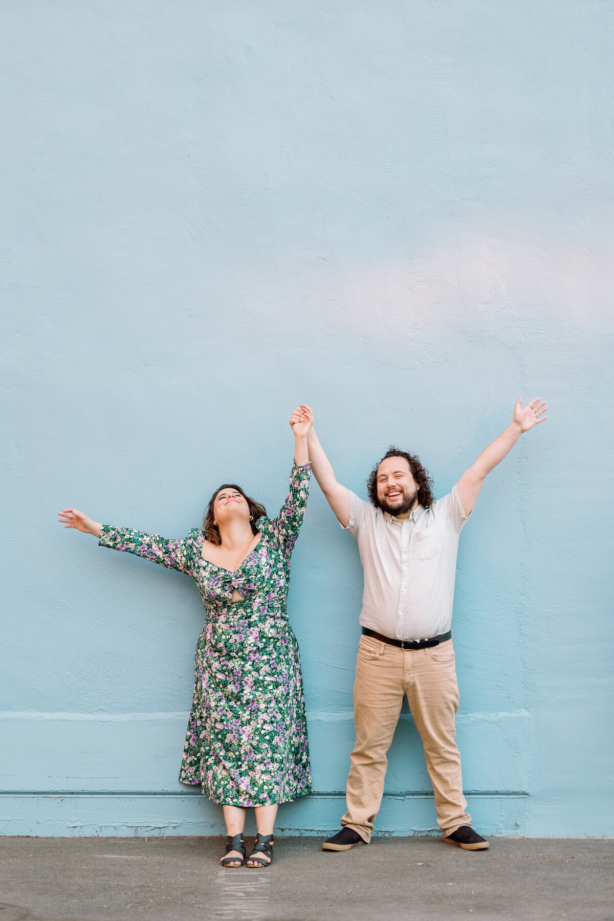 A couple with their arms raised above them