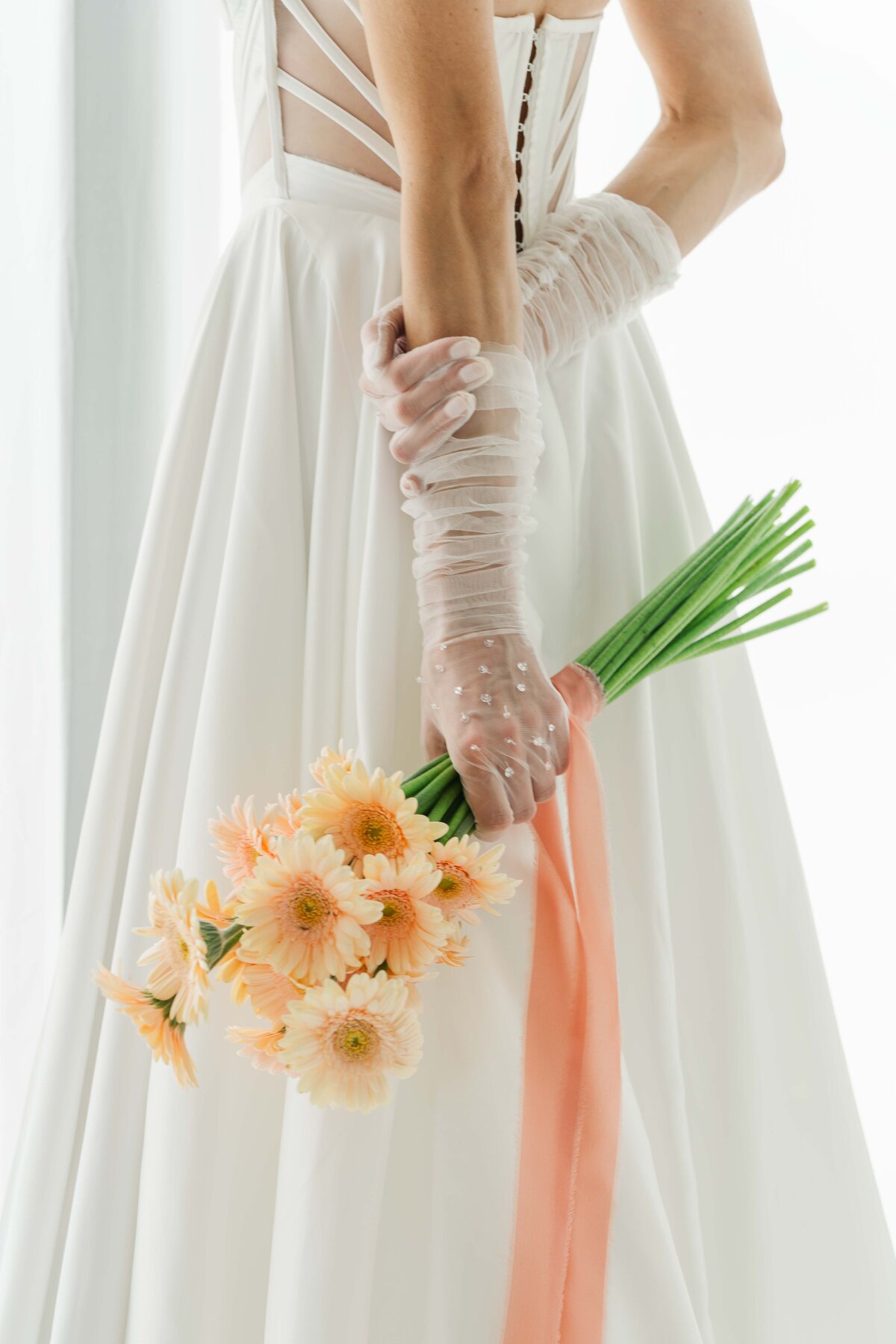 tangerine gerber wedding boquete while a bride hold it