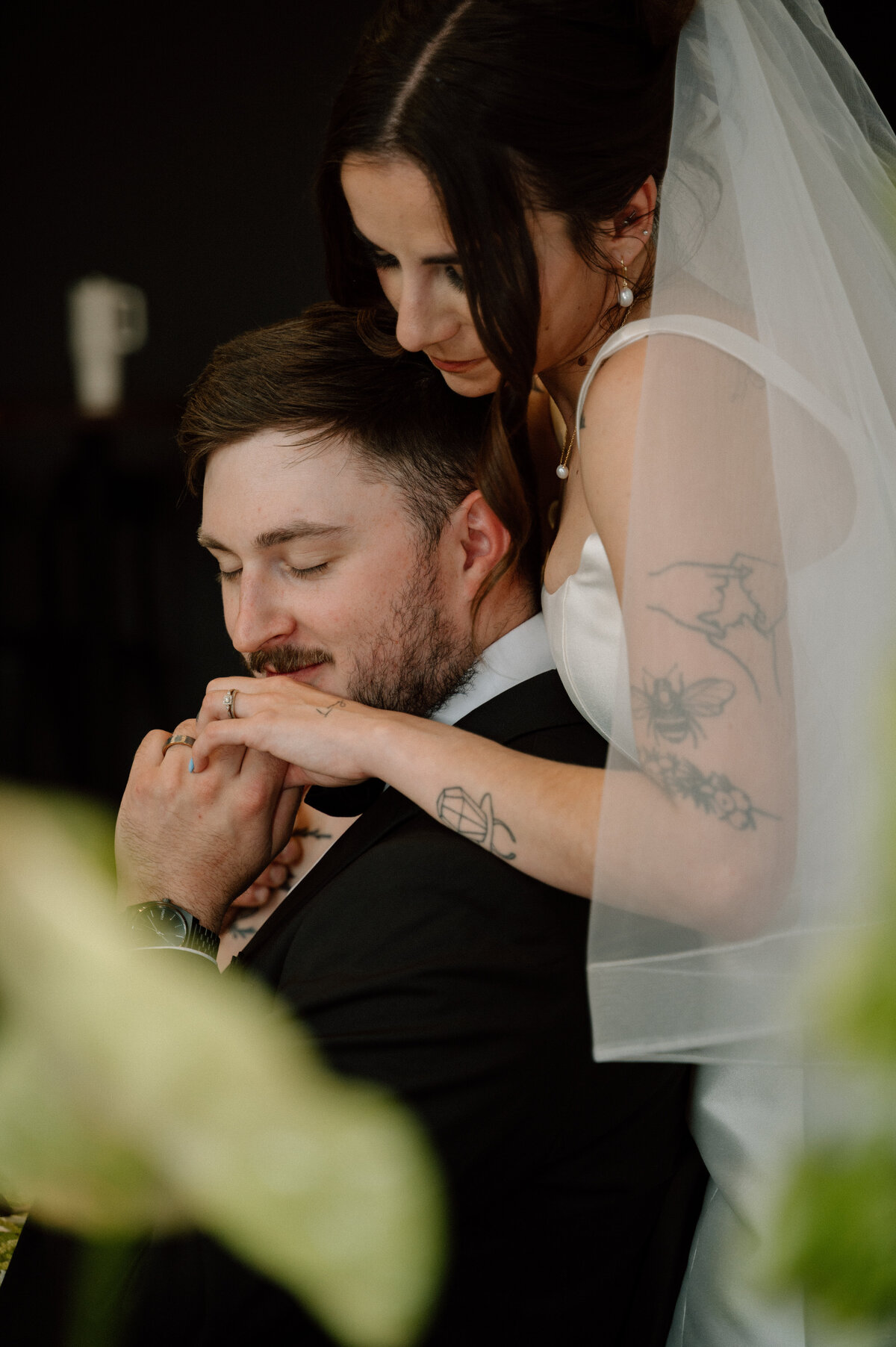 Emotional moment as bride rests on groom’s shoulder during intimate Banff reception.