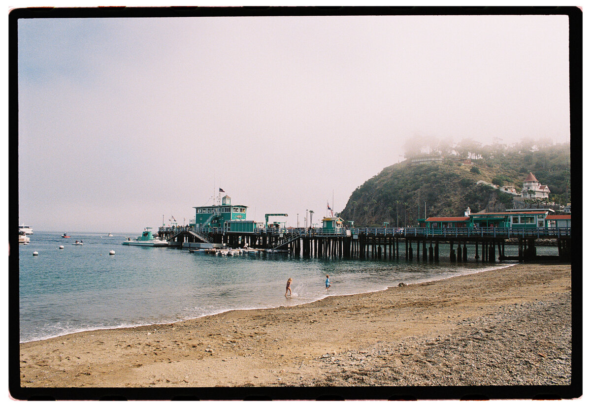 Catalina Island pier captured on film by Kate Winters Photography, showcasing the scenic beauty and authentic atmosphere in a documentary style.