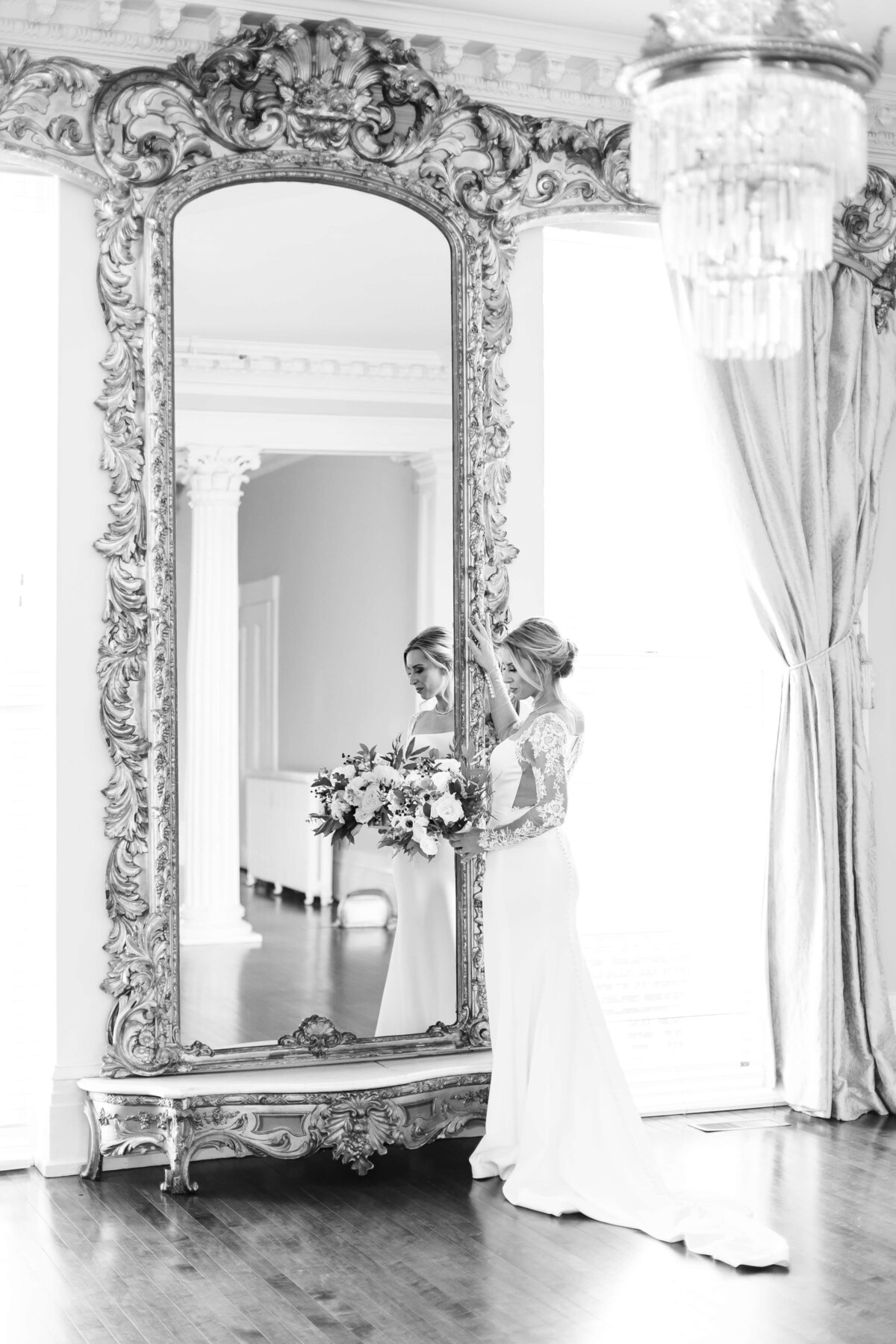 Bride looking in a large ornate mirror at the Carrick House, KY