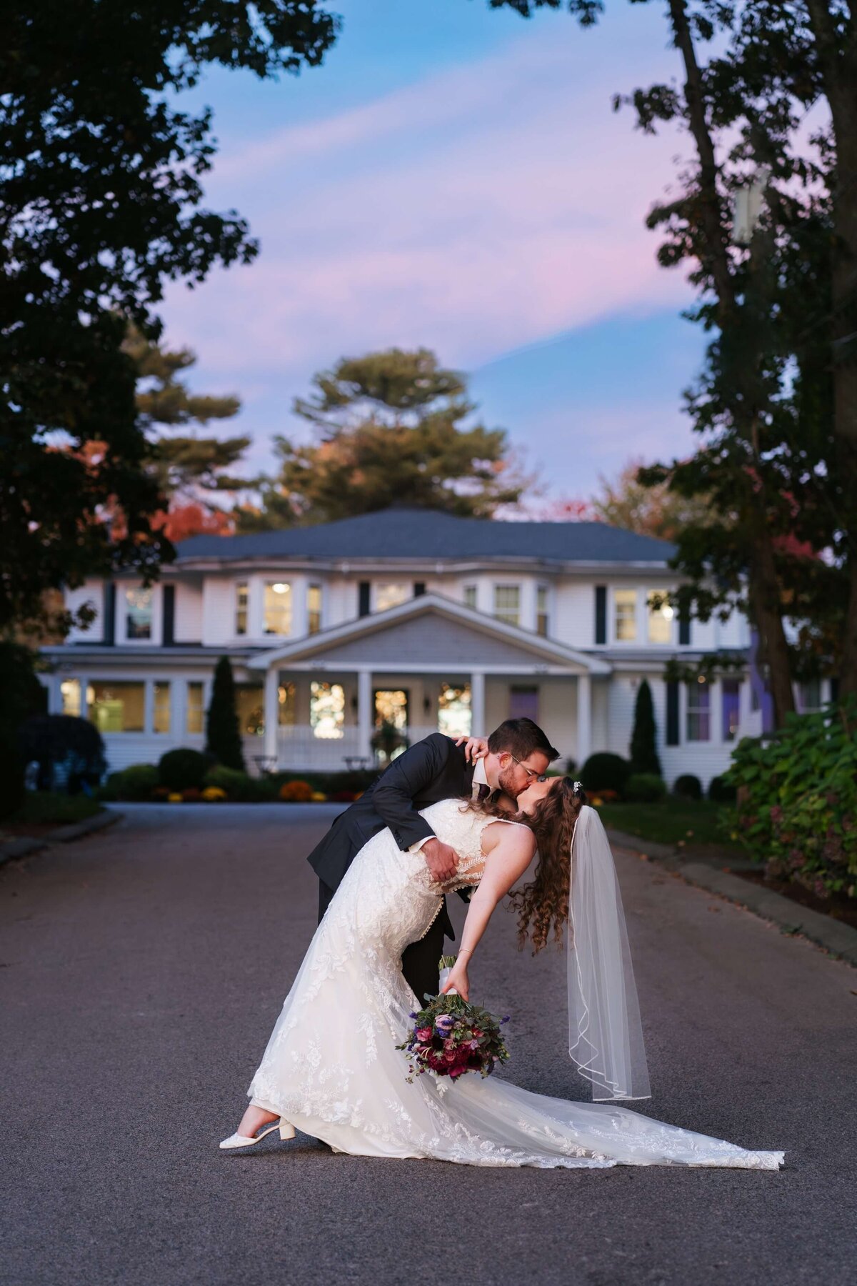 Couple doing a dip kiss outside of Saphire Estate in Sharon, MA