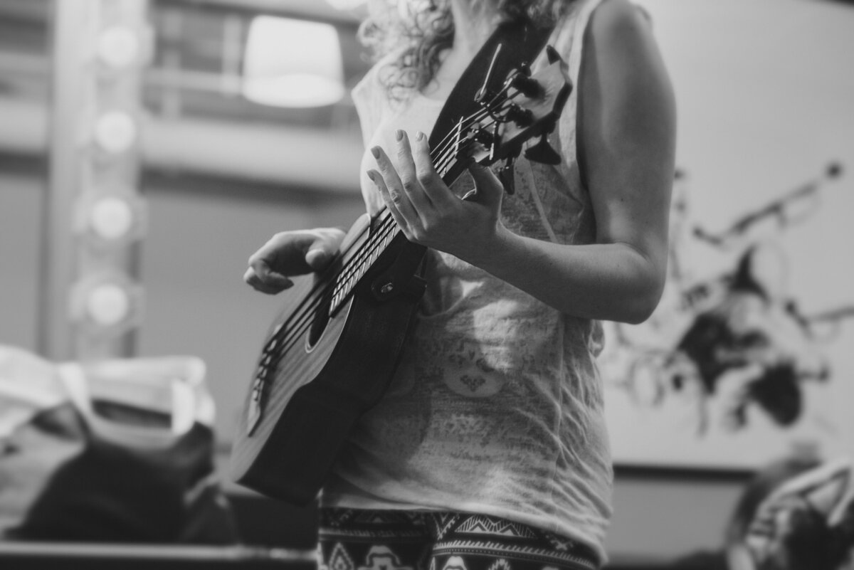 A close up of someone playing a ukelele