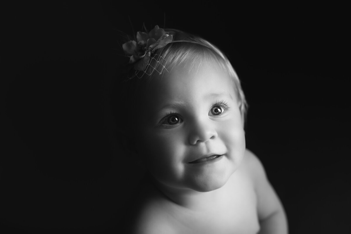 Black and white photo of six month baby smiling