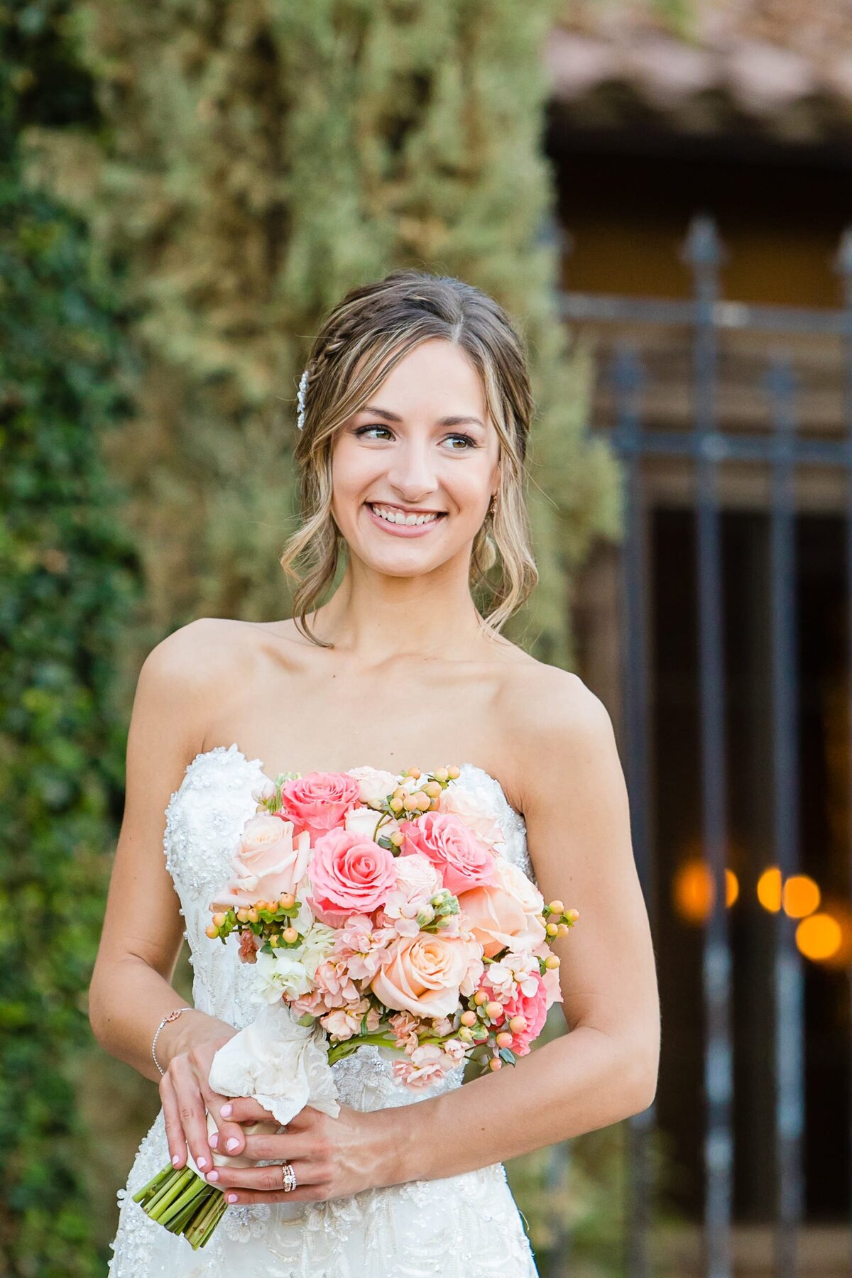 bride-smiling-holding-peach-and-pink-bouquet