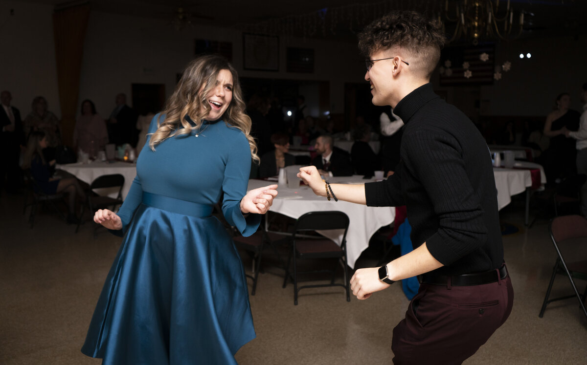 Photo of two friends dancing at a wedding reception