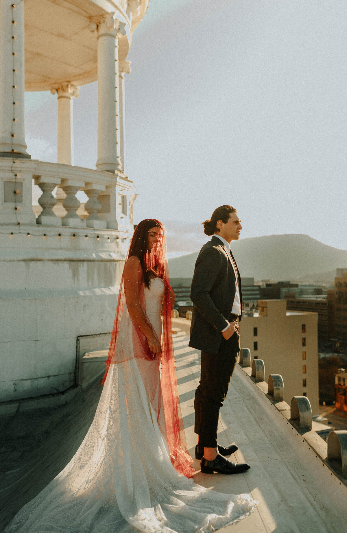 Bride in Red Veil on Rooftop with Mountains