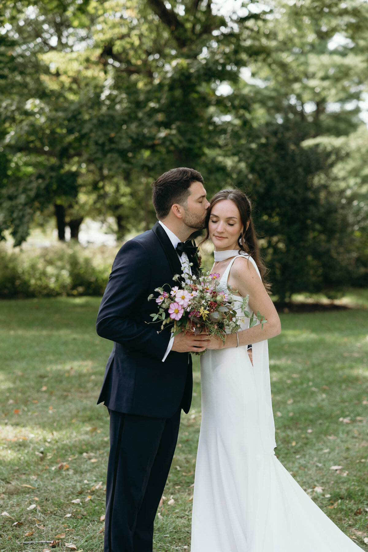 Bride and groom sharing a joyful moment outdoors, photographed by Ryann B Photography, an Indianapolis wedding photographer.