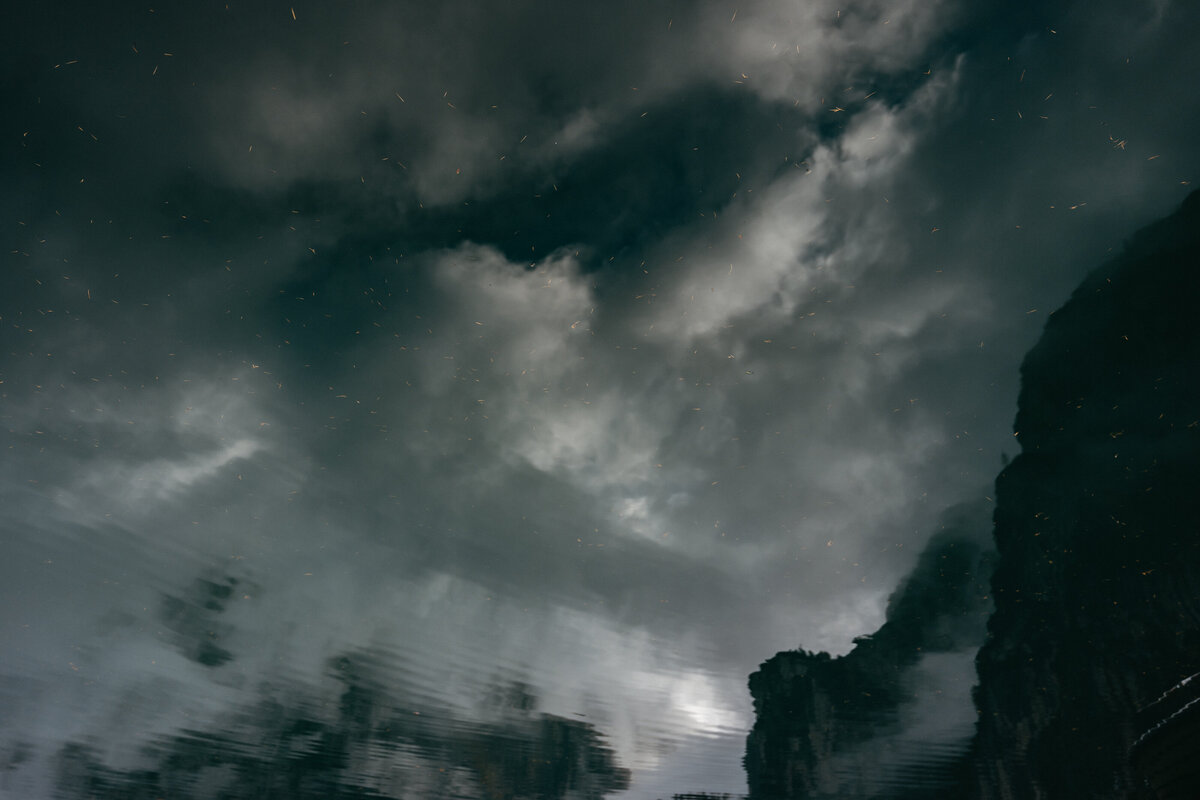 Dark clouds hanging over rugged mountain peaks