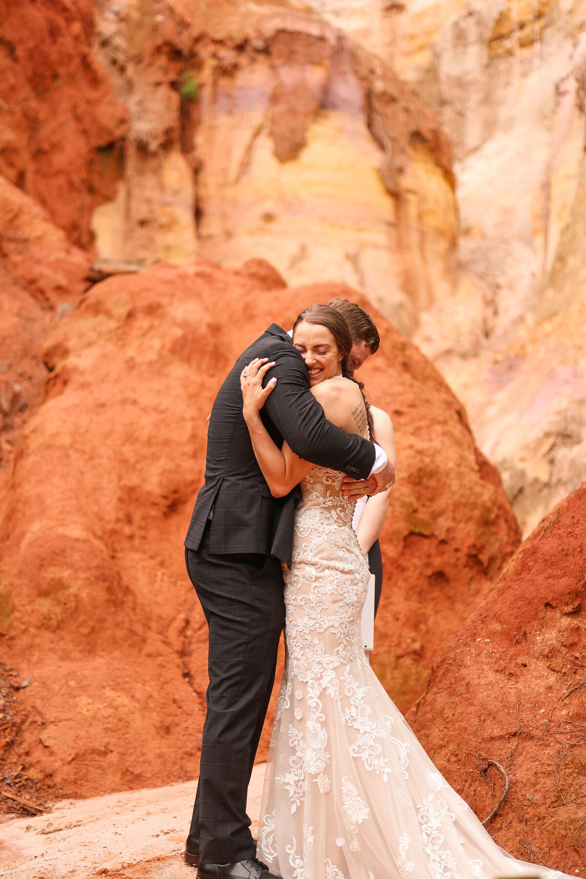 bride and groom hugging after being pronounced as husband and wife at providence canyon state park in lumpkin georgia by columbus georgia wedding photographer Amanda Richardson Photography