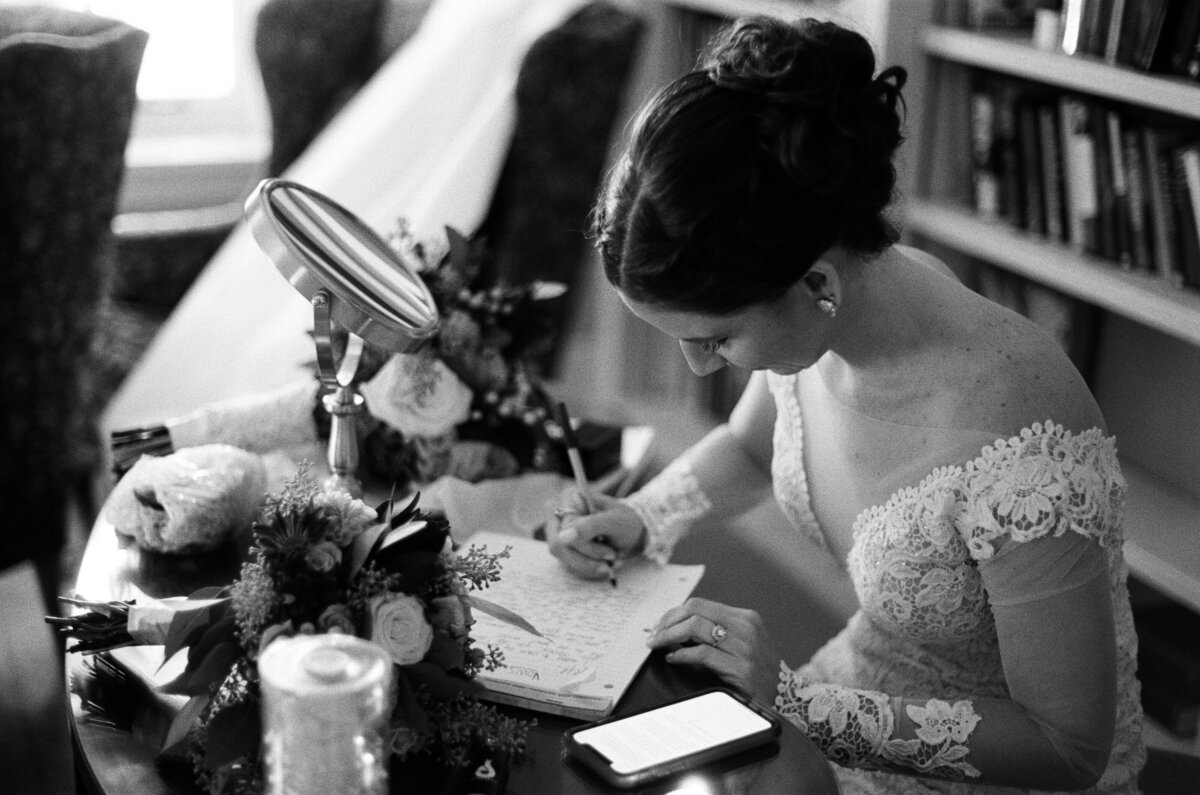 A bride writes her vows in her wedding dress at Succop Nature Preserve in Butler, PA