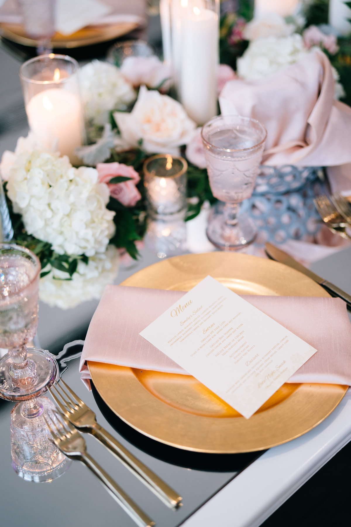 Blush napkin over gold charger tablescape