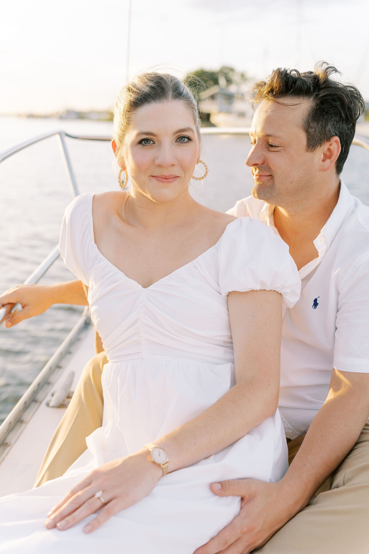 engaged couple riding on a sailboat