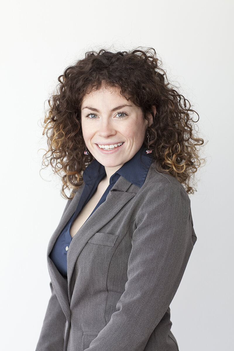 Business headshot of curly haired woman