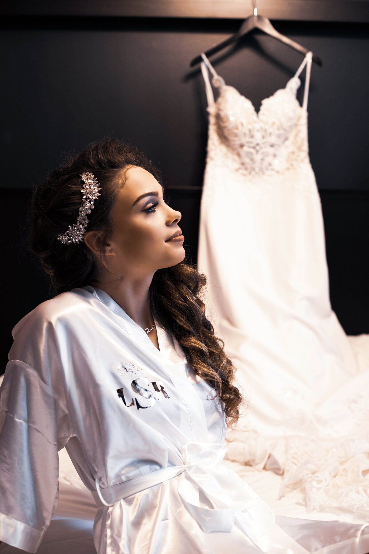 Bride-enjoys-wedding-day-prep-with-wedding-dress