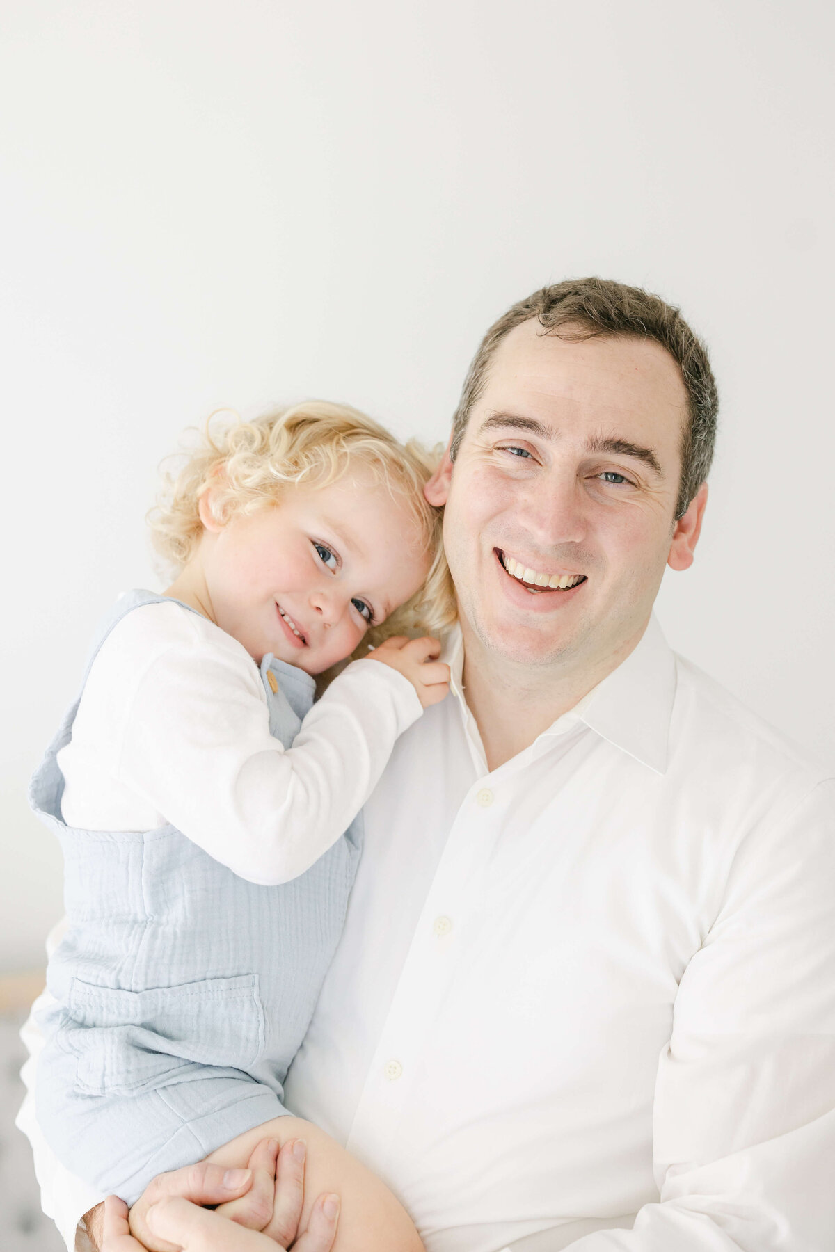 a dad and toddler smiling