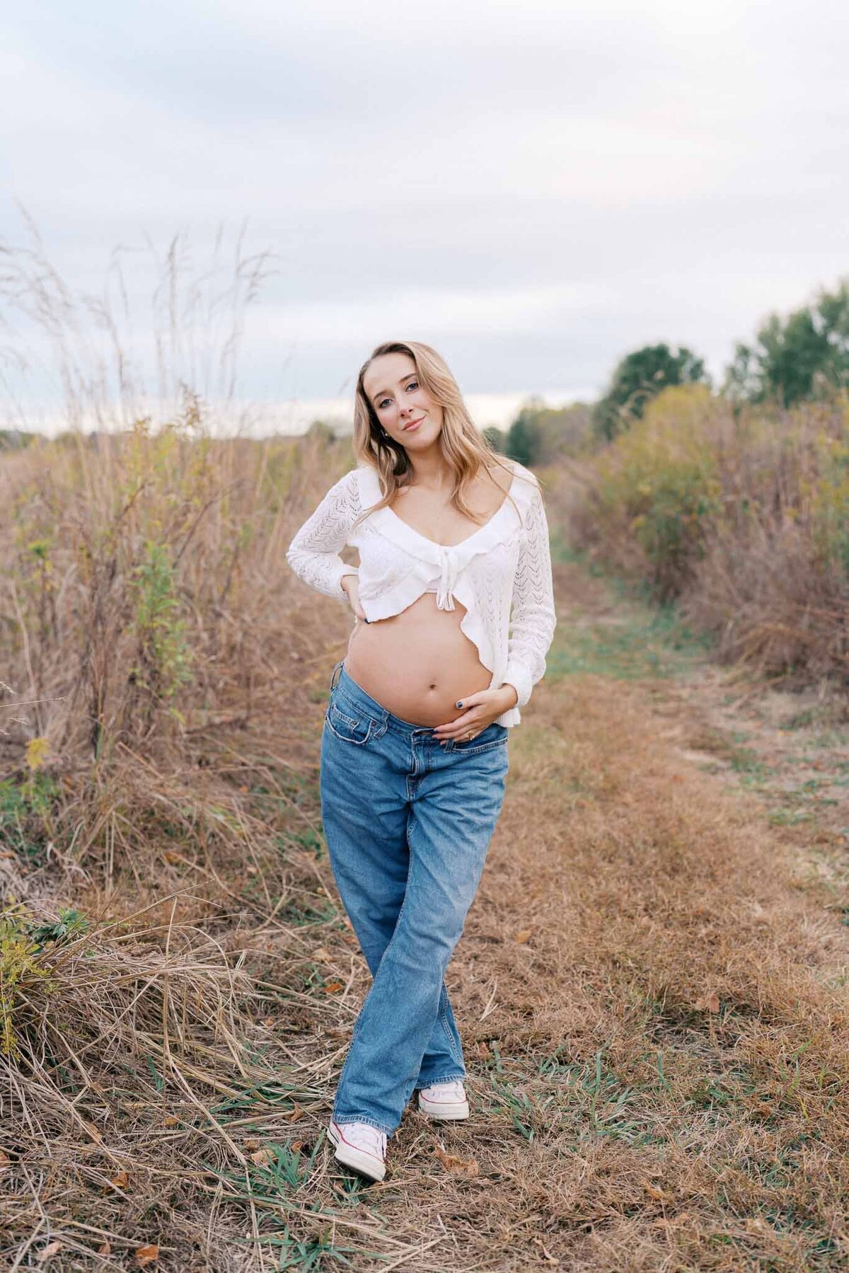 pregnant woman holds belly at seven islands state birding park in kodak tennessee