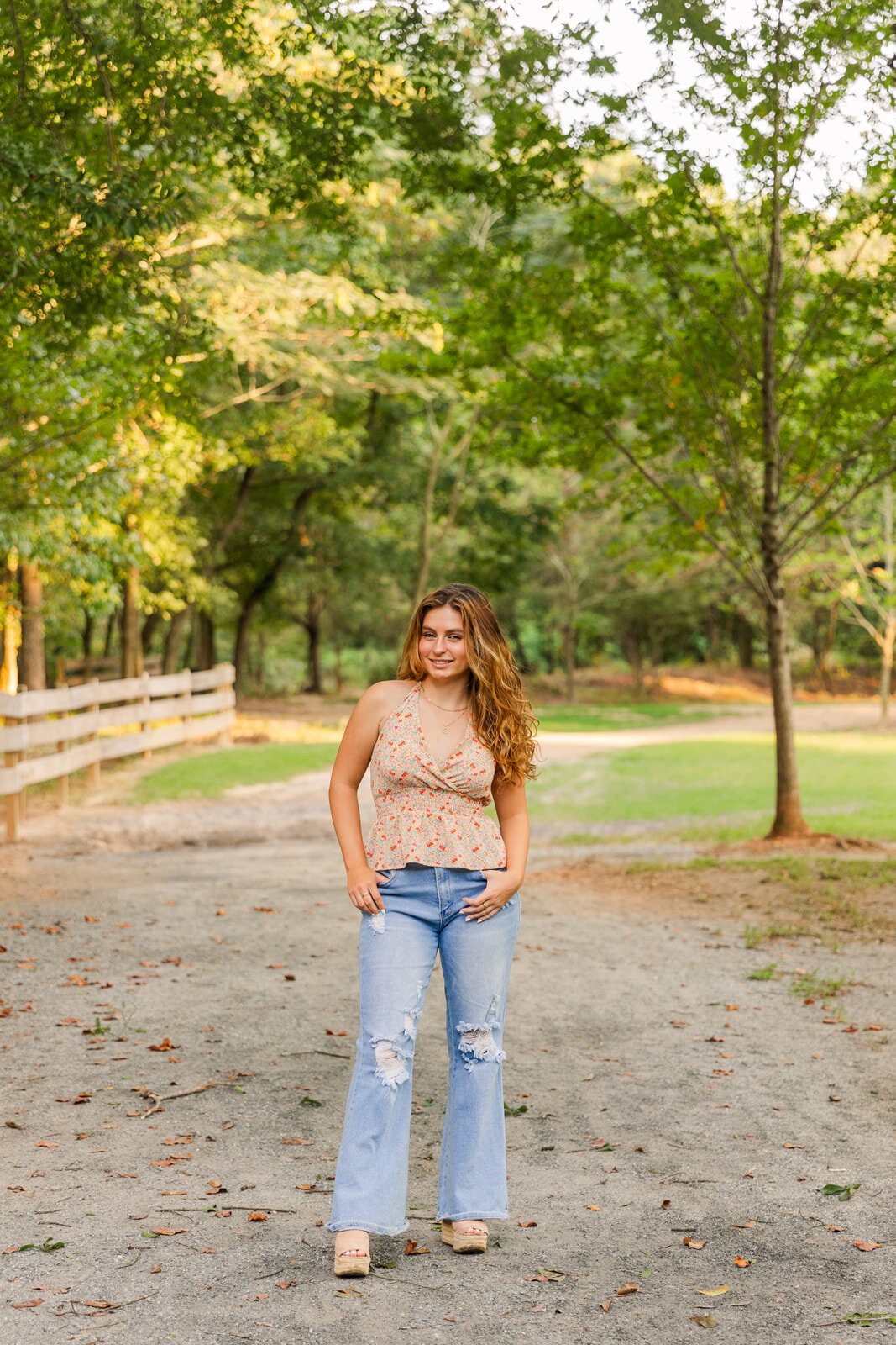 senior girl power pose in the middle of an Atlanta park path hands in pockets
