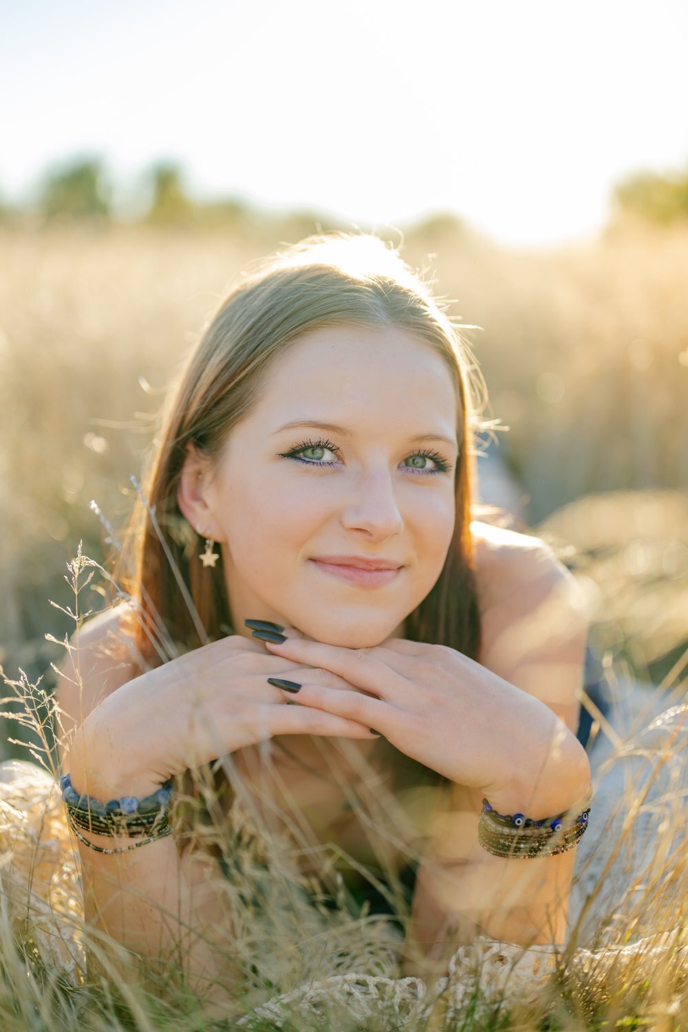 open field senior laying down summer