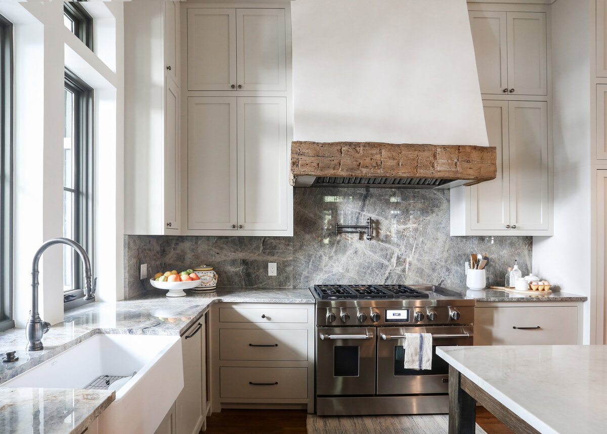 neutral-kitchen-white-cabinets-stucco-range-hood