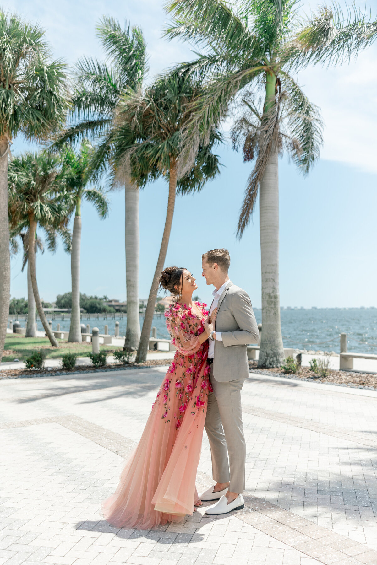 couple holding hands and embracing by sarasota florida wedding photography