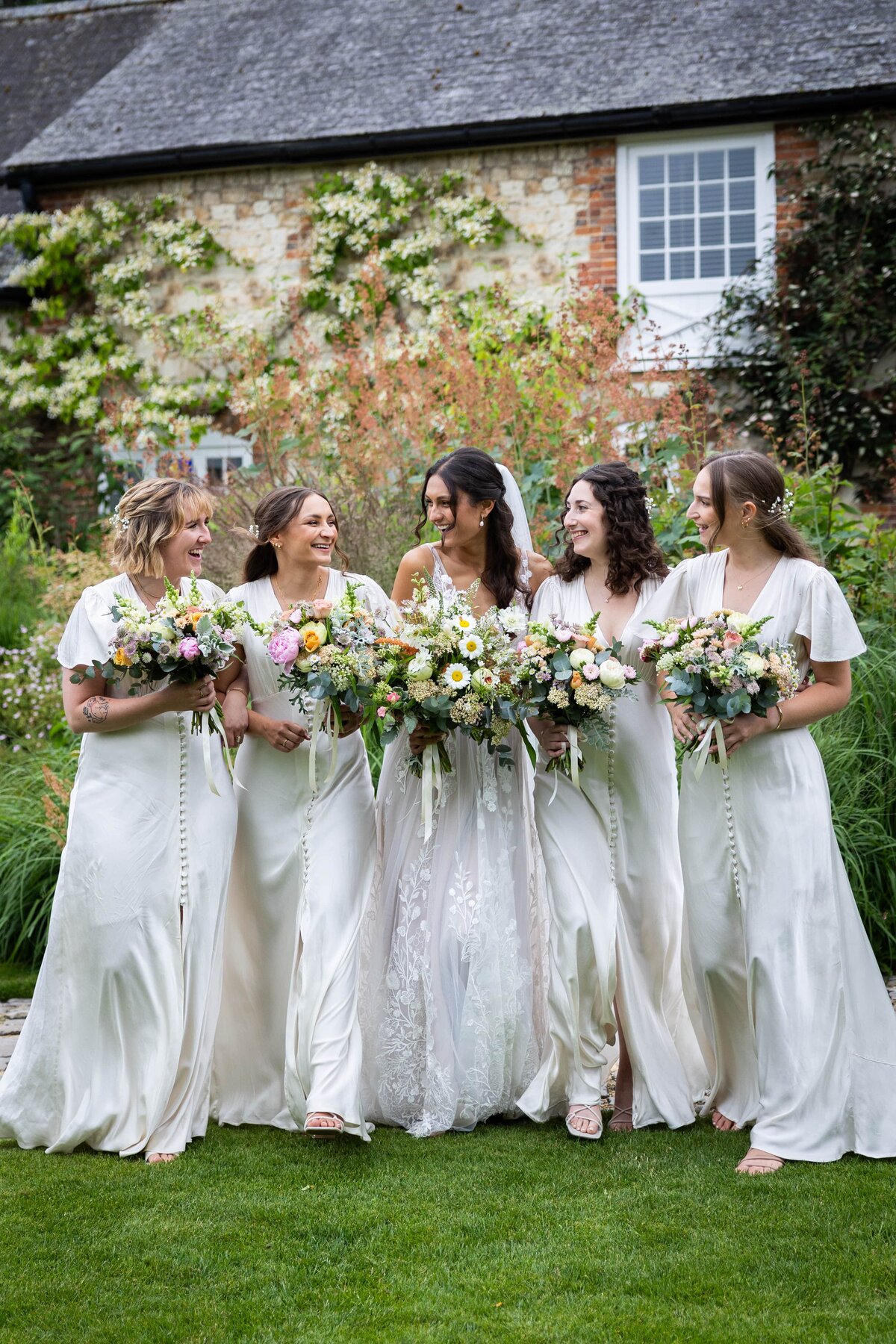 bride and bridesmaids walking and laughing