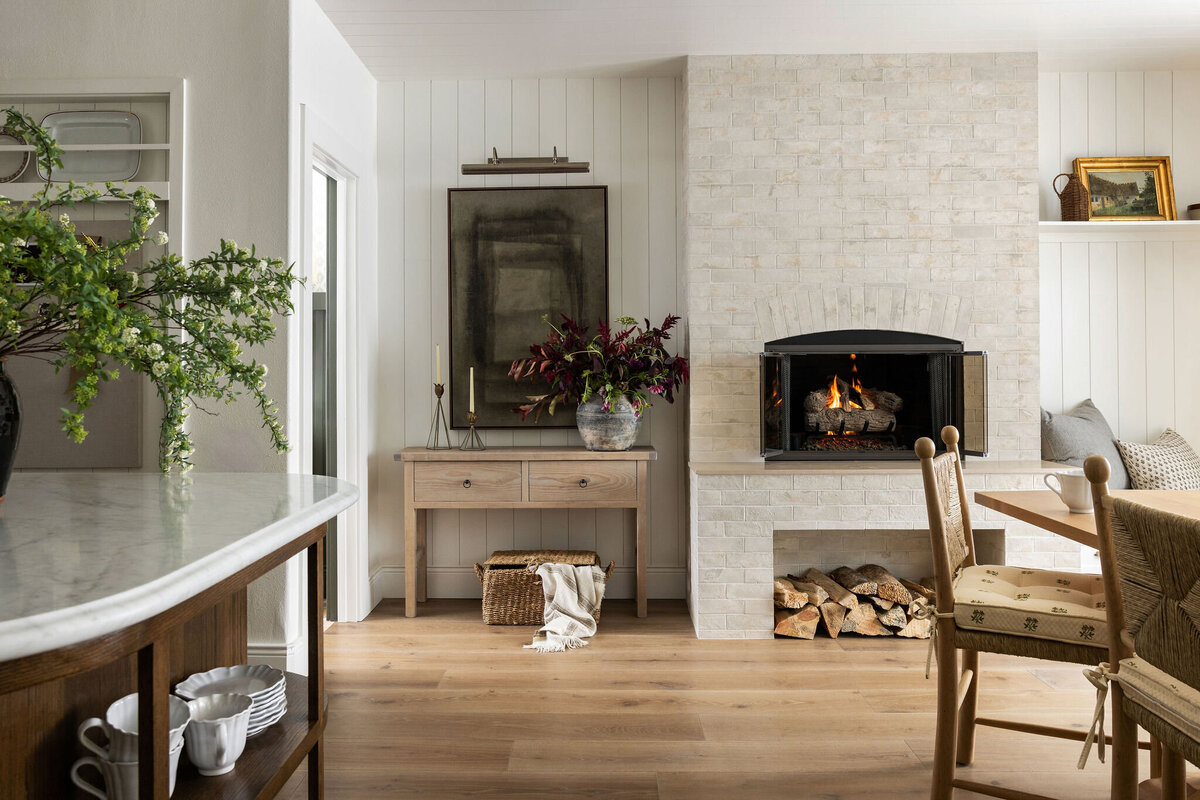 A visual example of our interior design services, featuring a cozy living room with fireplace and natural textures