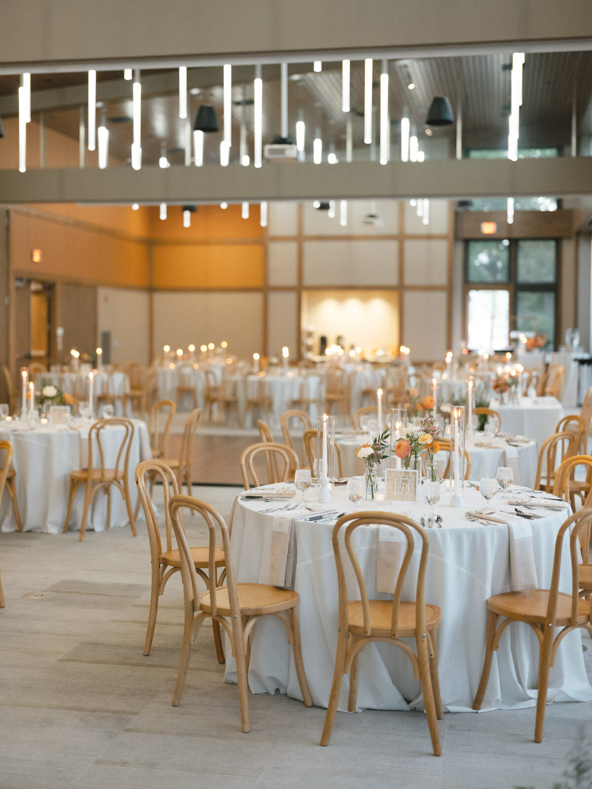 oregon wedding reception tables with wood chairs featuring custom calligraphy details by life in letters