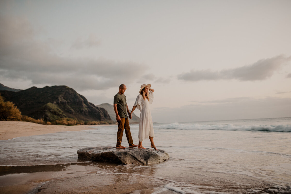 bride and groom walking by the ocean