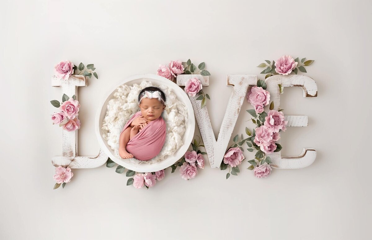 LOVE digital with newborn baby sleeping in the "O"