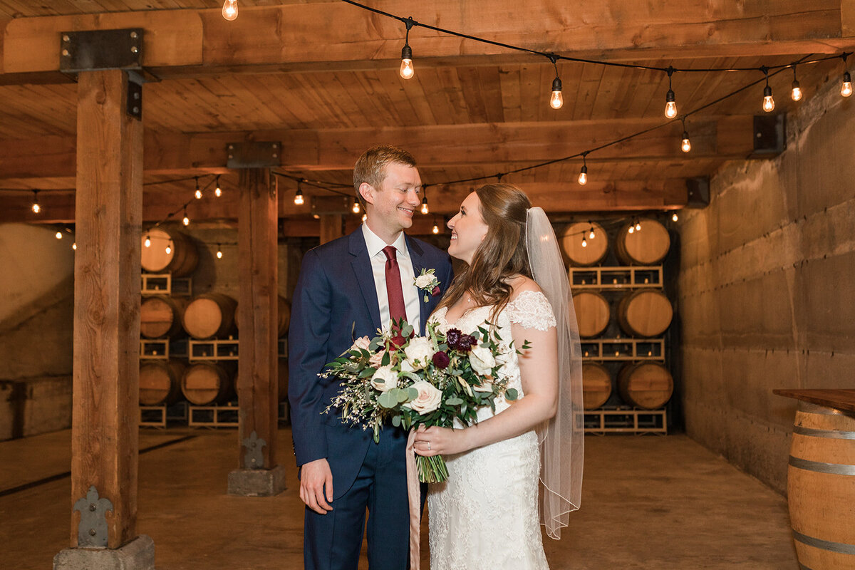 chateau lill woodinville winery bride and groom wedding photos in barrel room of vineyard. photos by Joanna Monger Photography