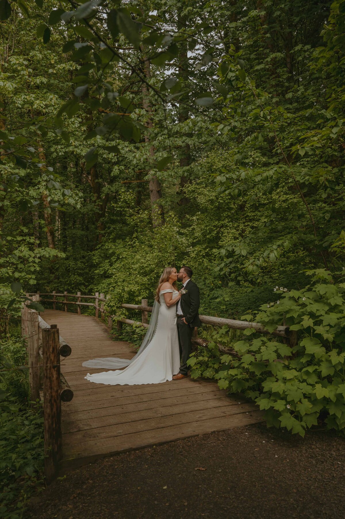 Bride and groom surrounded by greenery 